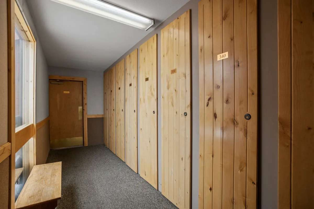 A practical, well-organized entry area with wooden lockers, a bench, and the main entrance. This space suggests secure storage and a welcoming transition between outdoor activities and indoor comfort.